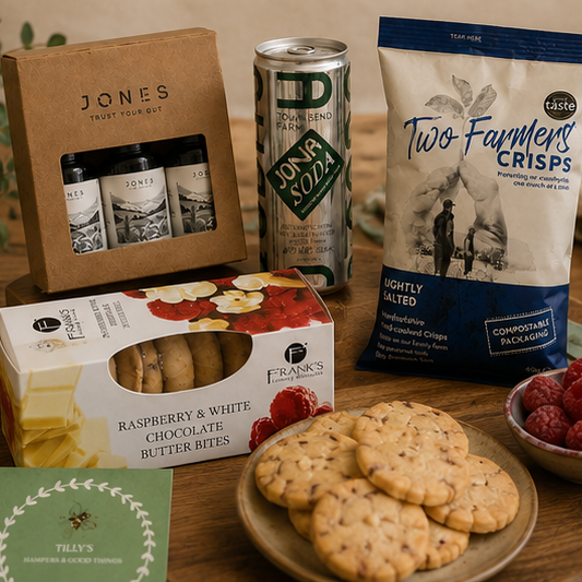 Assorted snacks and drinks on a wooden table with a plant and towel in the background.